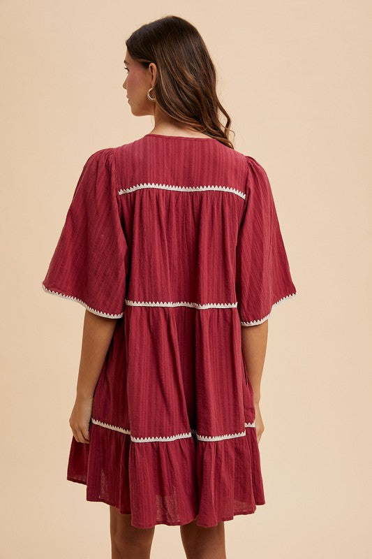 Aaliyah® | Tiered dress with tassels and contrast trim, tied neckline, half sleeves